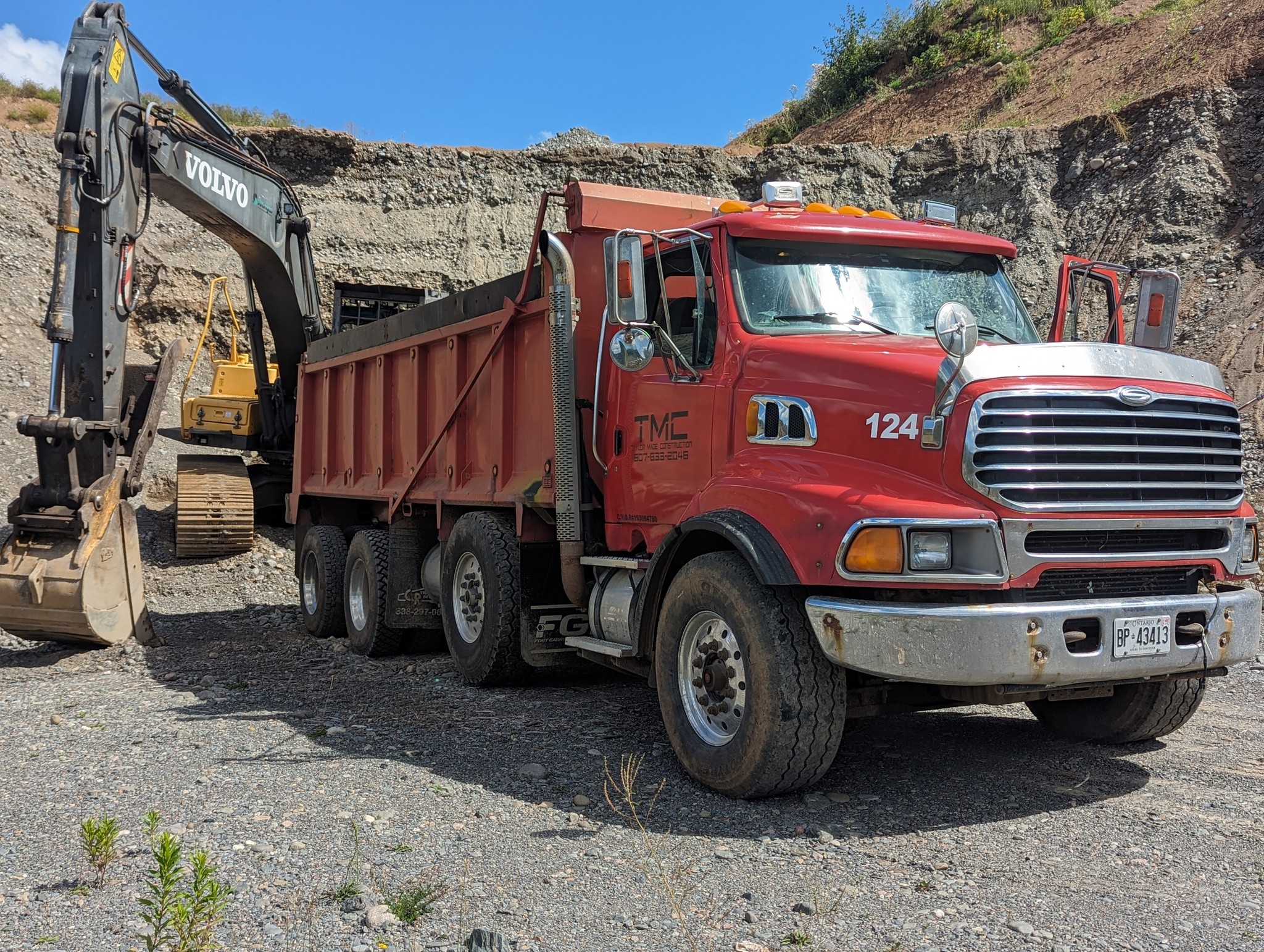 A Taylor Made Construction red dump truck